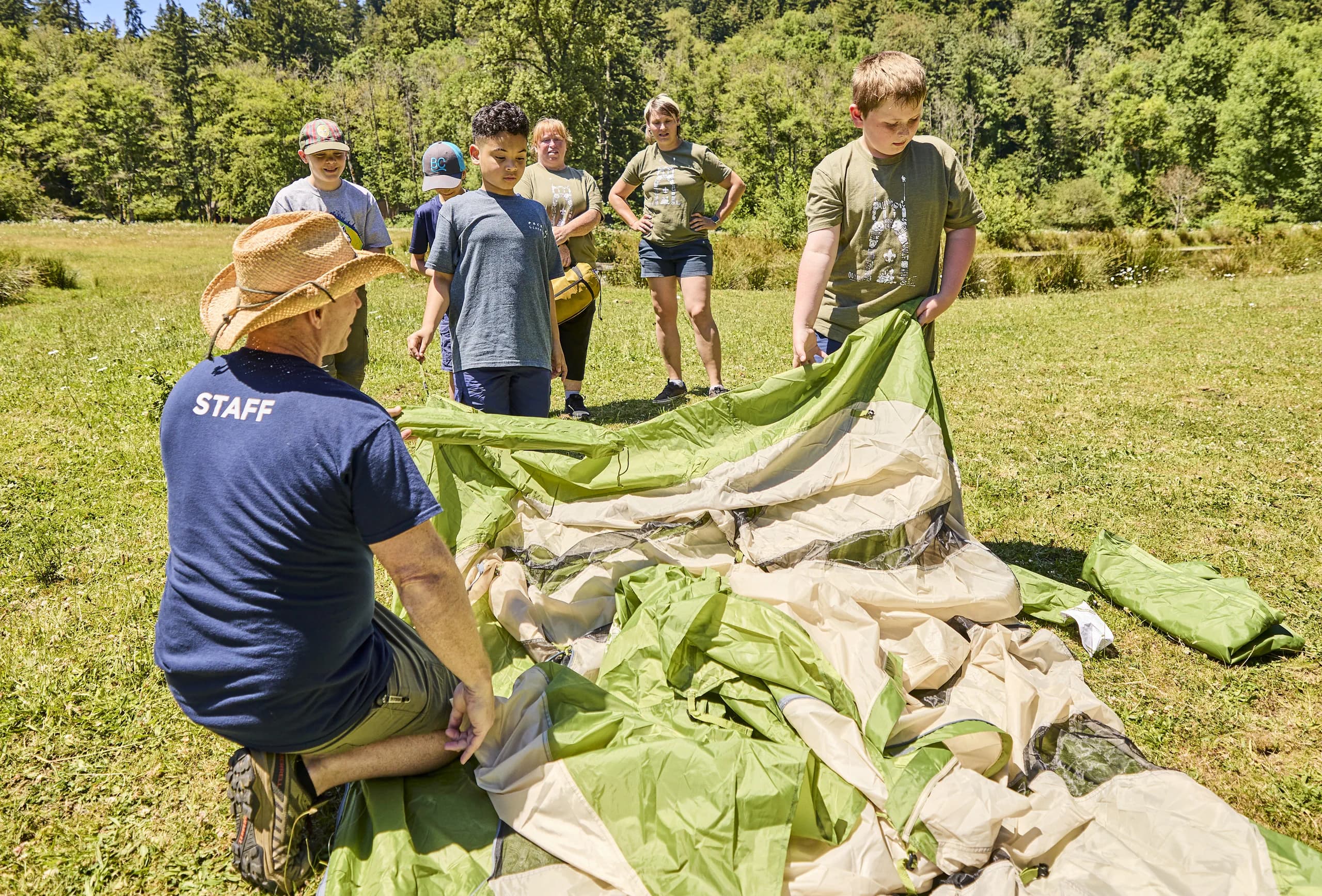 Pack 92 Scouts and leaders learning outdoor skills together.